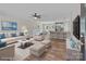 Staged open-concept living space with luxury vinyl plank flooring and a modern kitchen at 112 Cleveland Ave, Albemarle, NC 28001