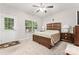 Bedroom with neutral carpet, wood-frame bed, a ceiling fan, and a window with a view at 1161 Constitution Park Blvd, Rock Hill, SC 29732