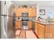 Well-lit kitchen features stainless steel appliances, wooden cabinets, and granite countertops at 1161 Constitution Park Blvd, Rock Hill, SC 29732