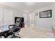 A cozy home office with neutral walls, plush carpeting, and a large office chair at 1161 Constitution Park Blvd, Rock Hill, SC 29732