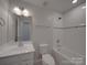 Bright bathroom with a vanity and tub/shower combination at 1210 Longwall Ln, Matthews, NC 28104