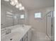 Bright bathroom with a double vanity and glass shower enclosure at 1210 Longwall Ln, Matthews, NC 28104