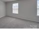 This bedroom has neutral carpet and lots of natural light at 1210 Longwall Ln, Matthews, NC 28104