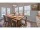 Sunlit dining room with seating for six, neutral decor, and an elegant light fixture at 1210 Longwall Ln, Matthews, NC 28104