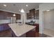 A modern kitchen features granite countertops, stainless appliances, and dark wood cabinets at 1210 Longwall Ln, Matthews, NC 28104