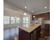 A modern kitchen with granite countertops, stainless steel appliances, and dark wood cabinets at 1210 Longwall Ln, Matthews, NC 28104