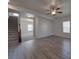 Spacious living room with an open floor plan, sleek flooring, and staircase access to upper level at 1210 Longwall Ln, Matthews, NC 28104