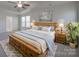 Spacious main bedroom with a large bed, tray ceiling, a ceiling fan, and serene decor at 1210 Longwall Ln, Matthews, NC 28104