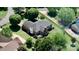 Aerial view of a brick home with a backyard deck, surrounded by lush greenery and mature trees, with a nearby neighborhood at 123 Shoreview Dr, Mooresville, NC 28117