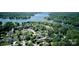 Aerial view of a neighborhood near a lake, showcasing a house surrounded by mature trees and lush greenery at 123 Shoreview Dr, Mooresville, NC 28117