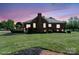 View of the home's backyard featuring a brick exterior, a deck, and manicured landscaping at 123 Shoreview Dr, Mooresville, NC 28117