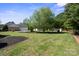 Expansive green backyard with a variety of trees and greenery, and large mulch beds at 123 Shoreview Dr, Mooresville, NC 28117