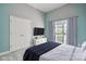 This staged bedroom has a large bed, a TV and a storage unit at 123 Shoreview Dr, Mooresville, NC 28117