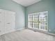 This empty bedroom has double doors and a view from the window at 123 Shoreview Dr, Mooresville, NC 28117