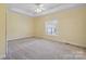 Spacious bedroom with neutral carpet, tray ceiling and plenty of natural light from the window at 123 Shoreview Dr, Mooresville, NC 28117