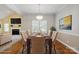 Formally staged dining room adjacent to living room featuring a large window for ample natural light at 123 Shoreview Dr, Mooresville, NC 28117