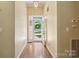 Inviting foyer with hardwood floors and a view of the landscaped front yard through the glass front door at 123 Shoreview Dr, Mooresville, NC 28117
