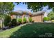 Charming single-story brick home with lush lawn and manicured bushes lining the front, creating a welcoming appeal at 123 Shoreview Dr, Mooresville, NC 28117