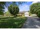 Inviting brick home with lush green lawn, mature trees, and a circular driveway leading to an attached two-car garage at 123 Shoreview Dr, Mooresville, NC 28117