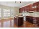 Well-lit kitchen featuring wood cabinets, a center island, and hardwood floors at 123 Shoreview Dr, Mooresville, NC 28117