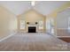 Spacious living room with vaulted ceilings, a cozy fireplace, and natural light from the french doors at 123 Shoreview Dr, Mooresville, NC 28117