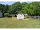 White shed with double doors situated in the backyard of this lovely property surrounded by trees at 123 Shoreview Dr, Mooresville, NC 28117