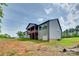 Exterior of home featuring covered patio, large backyard and views of the treeline and blue sky at 1336 W Rebound Rd, Indian Land, SC 29720