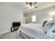 Bright bedroom with gray carpet, neutral walls, ceiling fan and a flatscreen television on a rustic wood stand at 1336 W Rebound Rd, Indian Land, SC 29720