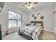Cozy bedroom with a ceiling fan, a neutral color scheme, and a large window at 1336 W Rebound Rd, Indian Land, SC 29720