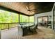 Inviting covered patio with outdoor seating, ceiling fan, and picturesque views of the surrounding greenery at 1336 W Rebound Rd, Indian Land, SC 29720