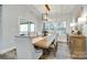 Light-filled dining room with wood table, chairs, modern light fixture, and access to the porch at 1336 W Rebound Rd, Indian Land, SC 29720