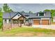 Beautiful two-story home featuring stone accents, a welcoming porch, an attached two car garage, and manicured lawn at 1336 W Rebound Rd, Indian Land, SC 29720