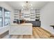 Bright home office featuring custom built-in shelving, modern lighting, and a spacious desk area at 1336 W Rebound Rd, Indian Land, SC 29720