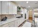 Bright, modern kitchen featuring white cabinetry, granite countertops, and stainless steel appliances at 1336 W Rebound Rd, Indian Land, SC 29720