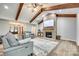 Cozy living room featuring a stone fireplace, wood beams, and a view into the foyer at 1336 W Rebound Rd, Indian Land, SC 29720