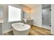 A bright main bathroom with a freestanding tub, dual vanities, and separate shower area at 1336 W Rebound Rd, Indian Land, SC 29720