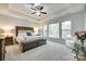 Main bedroom with large windows, tray ceiling, carpet flooring, and stylish furniture at 1336 W Rebound Rd, Indian Land, SC 29720
