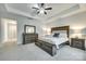 Spacious main bedroom with a tray ceiling, carpet, and an elegant furniture set at 1336 W Rebound Rd, Indian Land, SC 29720