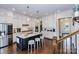 Bright kitchen featuring white cabinetry, a marble island with seating, and stainless steel appliances at 1358 Cedardale Ln, Denver, NC 28037