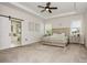 A spacious main bedroom with ceiling fan and an attached bathroom, and filled with natural light at 1358 Cedardale Ln, Denver, NC 28037