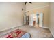 Spacious primary bedroom with high ceilings and access to the ensuite bathroom and walk-in closet at 13936 Mallard Lake Rd, Charlotte, NC 28262
