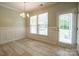 Bright dining area with wainscoting, large windows, and easy access to the backyard at 13936 Mallard Lake Rd, Charlotte, NC 28262