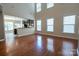 Spacious living room with hardwood floors, flooded with natural light from large windows at 13936 Mallard Lake Rd, Charlotte, NC 28262