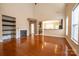 Bright living room featuring gleaming hardwood floors, fireplace, and ample natural light at 13936 Mallard Lake Rd, Charlotte, NC 28262