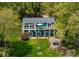 Aerial shot of a beautiful lake house, showcasing its well-manicured lawn, stone patio, and inviting outdoor spaces at 1430 Mollys Backbone Rd, Catawba, NC 28609