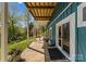 Inviting back porch with wood ceiling and columns overlooks lush greenery and landscaping at 1430 Mollys Backbone Rd, Catawba, NC 28609
