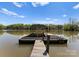 Well-maintained boat dock with a covered slip and ladder, providing direct access to the tranquil lake waters at 1430 Mollys Backbone Rd, Catawba, NC 28609