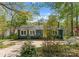 Quaint home with vibrant yellow front door and beautiful surrounding greenery at 1430 Mollys Backbone Rd, Catawba, NC 28609