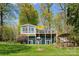 Charming two-story lake house with a sunroom, balconies, well-manicured lawn, and inviting outdoor spaces at 1430 Mollys Backbone Rd, Catawba, NC 28609