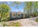 Charming waterfront home featuring a bright yellow door and mature trees at 1430 Mollys Backbone Rd, Catawba, NC 28609